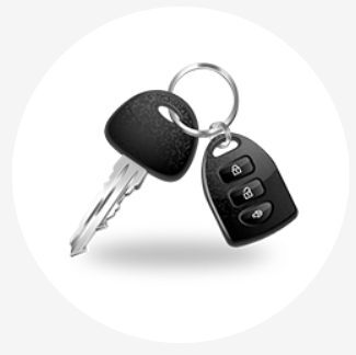 A pair of keys with a car key on top.